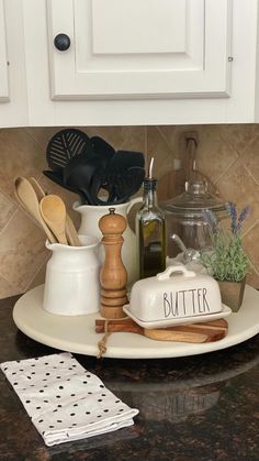 kitchen utensils are sitting on a plate in front of the counter top,