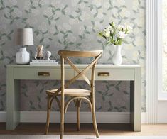 a wooden chair sitting in front of a desk with flowers on it