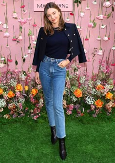 a woman standing in front of a flower display