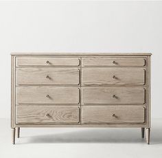 a large wooden dresser sitting on top of a white floor