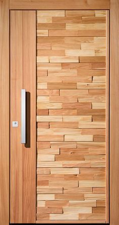 a wooden door with a metal handle on it's side and wood paneling