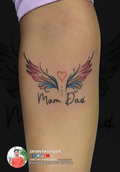 a woman with a tattoo on her leg that reads mom dust and has angel wings