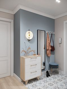 a bathroom with blue walls and white furniture in the corner, including a coat rack