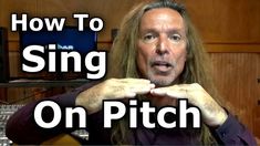 a man with long hair is holding his hands up in front of him and the words how to sing on pitch