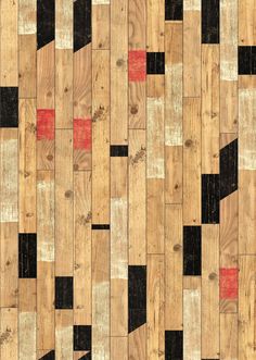 a wooden floor with black, red and white squares on the wood grained surface