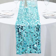 the table runner is decorated with blue sequins