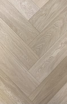 an image of wood flooring that looks like herringbones