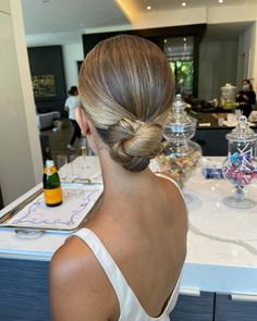 a woman with blonde hair in a low bun