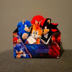 sonic the hedgehog and other stuffed animals in a box