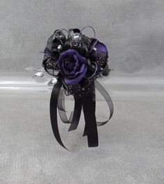 a bridal bouquet with black and purple flowers