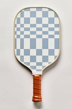 a blue and white checkered tennis racket with wooden handle