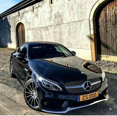 a black car parked in front of a building