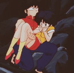 an animated image of two people sitting on the ground, one is holding the other