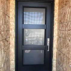 a black door on a stone building