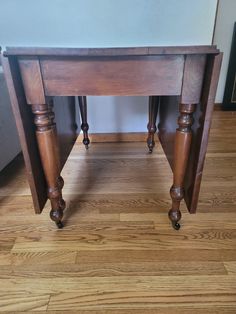 an old wooden table with two legs on it