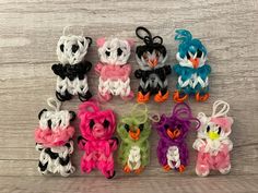 several small crocheted stuffed animals sitting next to each other on a wooden surface