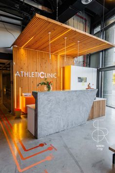 the interior of a building with an open counter and yellow lighting on it's side