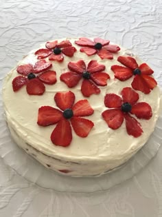 a cake with white frosting and strawberries on top