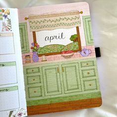 an open planner book with the words april written on it