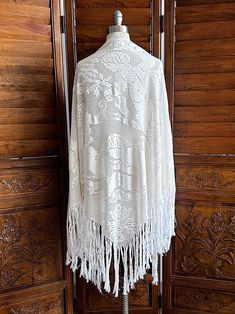 Vintage knit white shawl with fringe  Appears to be floral and cherub print  Large size - has some very faint yellowing and one spot - I have not tried to clean see photos  90" x 36" with 10" fringe Bohemian White Shawl With Fringe, White Bohemian Shawl With Fringe, Bohemian Cream Shawl With Fringe, White Bohemian Shawl With Tassels, Bohemian White Shawl With Tassels, White Shawl Scarf For Summer, One-size White Shawl For Summer, Vintage White Shawl Scarf, White Vintage Shawl Scarves