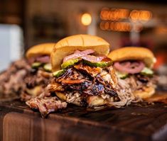 two pulled pork sandwiches on a cutting board