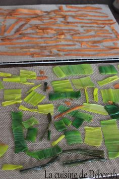 some green and orange strips of food on a table next to a tray with carrots