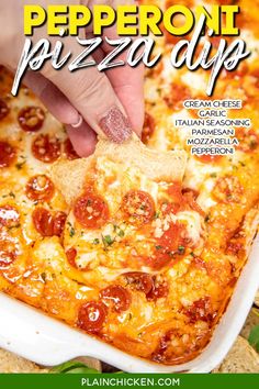 a person dipping a piece of pizza into a casserole dish with cheese and pepperoni