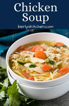 a white bowl filled with chicken soup and garnished with parsley on the side