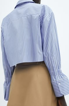 Thin, vertical stripes maximize the clean, crisp look of this button-up shirt in a cropped length with elastic bands above the one-button cuffs. Hidden-button placket Point collar Long sleeves with one-button cuffs 36% viscose, 33% polyester, 31% cotton Machine wash, line dry Imported Womens Business Attire Professional, Blue Striped Shirt Outfit, Tweed Jacket Outfit, Womens Business Attire, Cropped Button Up Shirt, Skater Shirts, Stripped Tops, Blue Striped Shirt, Shirt Cuff