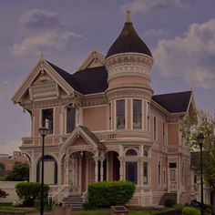 an old victorian style house with a clock on the front