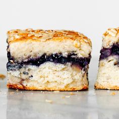 two pieces of blueberry cake sitting on top of a counter