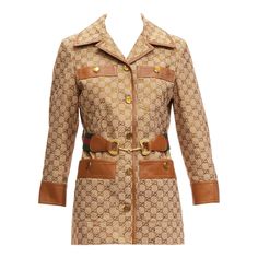 GUCCI 2022 Aria crystal embellished Horsebit web belt GG canvas jacket IT38 XS Reference: AAWC/A00487 Brand: Gucci Designer: Alessandro Michele Model: Aria Collection: 2022 Material: Cotton, Leather Color: Brown, Yellow Pattern: Monogram Closure: Button Lining: Cream Fabric Extra Details: Gucci's jacket harks back to chic '70s styles. It's tailored from cotton-blend canvas-jacquard that's decorated with tiny crystals in the form of the 'GG' monogram and trimmed with tan leather at the collar, pockets and cuffs. The striped webbing belt and horsebit hardware nod to the brand's equestrian heritage. Estimated Retail Price: USD 10000 Made in: Italy CONDITION: Condition: Very good, this item was pre-owned and is in very good condition. Please refer to image gallery for thorough condition check. Gucci 2022, Shiatzy Chen, Cocoon Jackets, Shawl Collar Blazer, Gucci Jacket, Web Belt, Gucci Brand, Guccio Gucci, Gucci Outfits