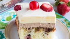 a slice of cake with white frosting and strawberries on top is sitting on a plate