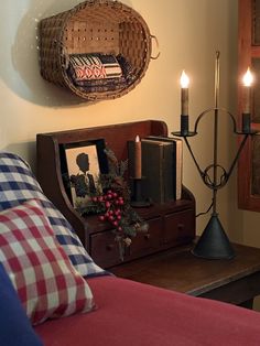 a living room with candles and pictures on the wall