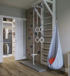 a room with a hammock hanging from it's ceiling and closets