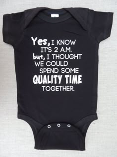 a black onesie with white writing on it