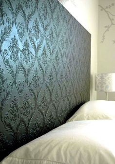 the headboard is made up to look like an intricate wallpaper