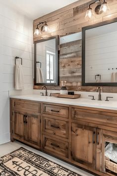 a large bathroom with two sinks and mirrors