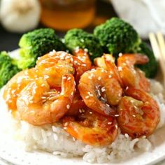 shrimp, broccoli and rice on a plate with chopsticks