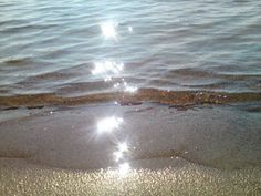 the sun shines brightly in the water at the beach