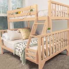 a wooden bunk bed sitting next to a window