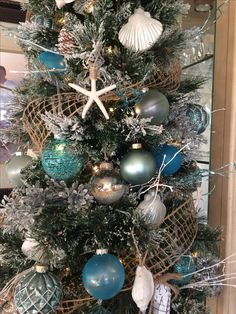 a christmas tree decorated with blue and silver ornaments