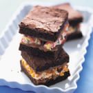 three brownies on a white plate with sprinkles