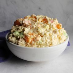 a white bowl filled with food on top of a table