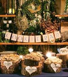 a table topped with lots of desserts and candles