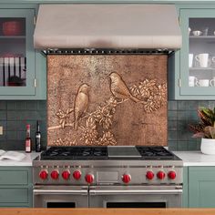 a stove top oven sitting inside of a kitchen next to a wall with a heart on it