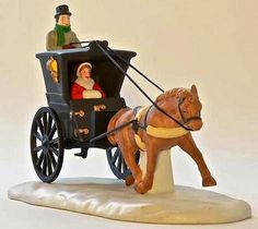 a figurine of a man riding in a horse drawn carriage with a woman