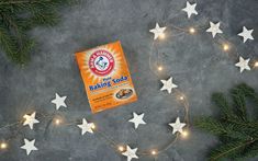 a box of baking soda sitting on top of a table next to some christmas lights