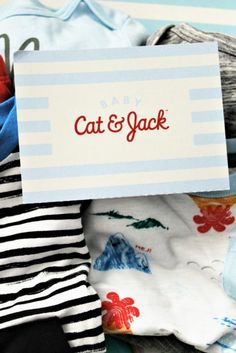 a pile of clothes with a sign that says cat and jack