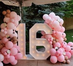 balloons and flowers are arranged in the shape of numbers for a birthday party or celebration